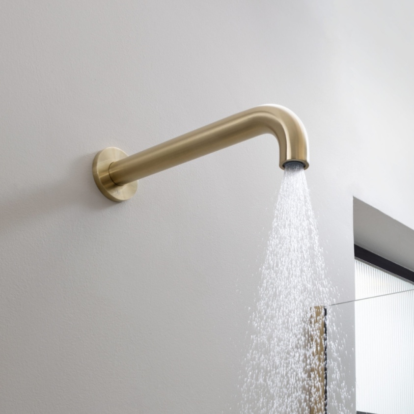 Close up product lifestyle image of the JTP Vos Brushed Brass Cylindrical Shower Head